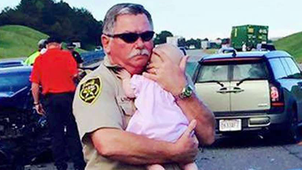 Deputy comforts crying baby after car crash