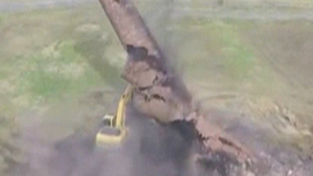 Demolition fail: Falling smokestack buries excavator, driver