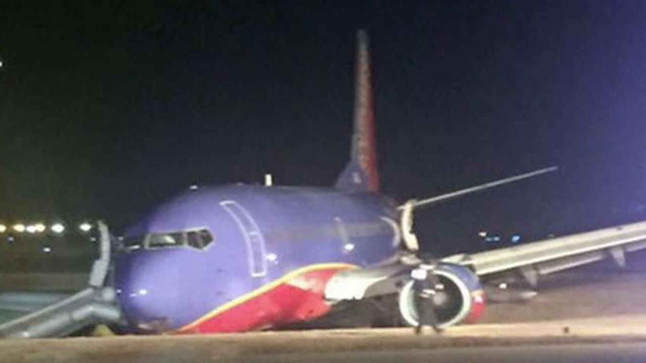 8 hurt after a Southwest jet skids off runway into ditch