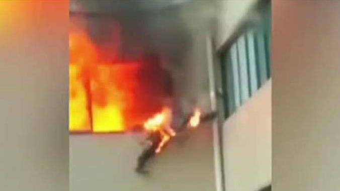 Shocking video: Firefighter jumps from burning building