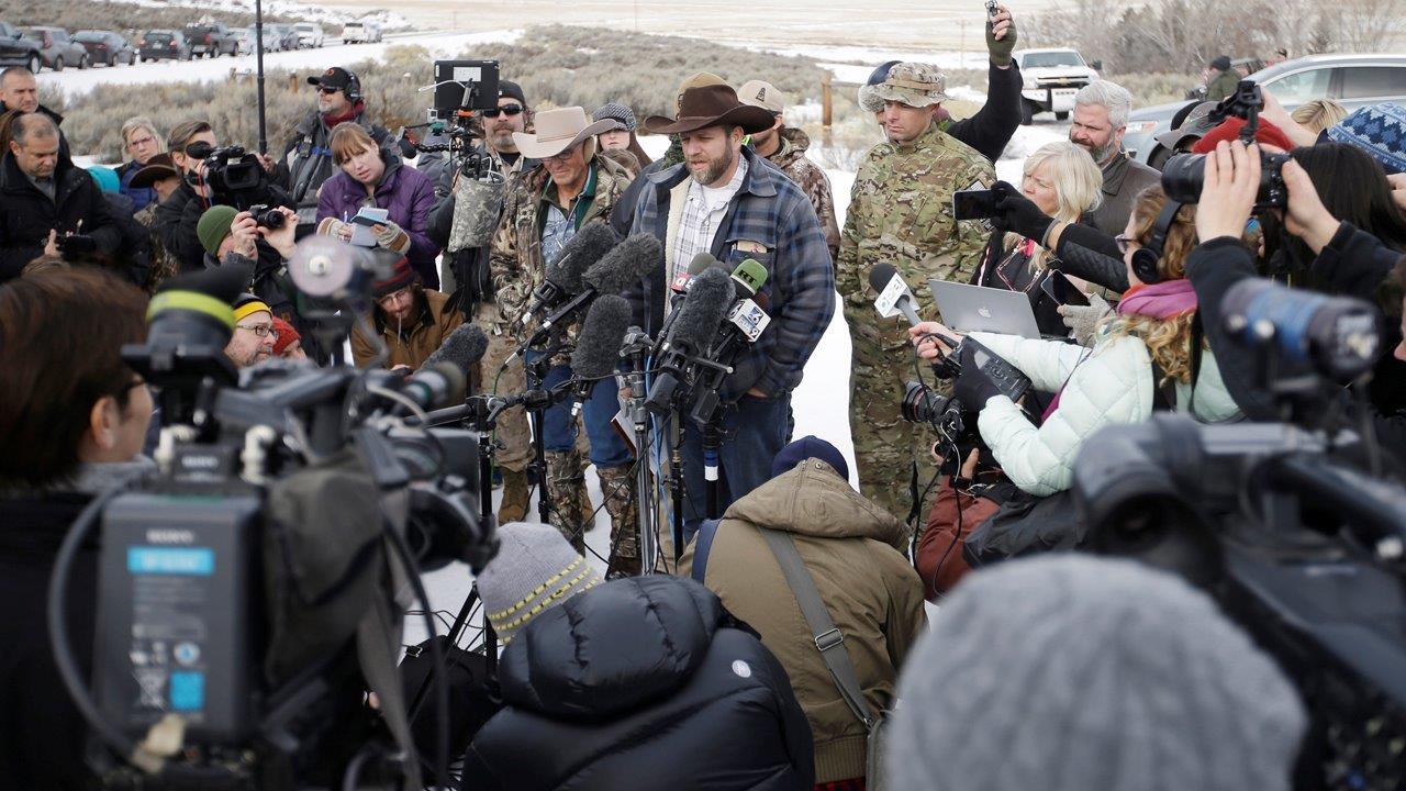 Rancher family reports to prison, armed standoff continues