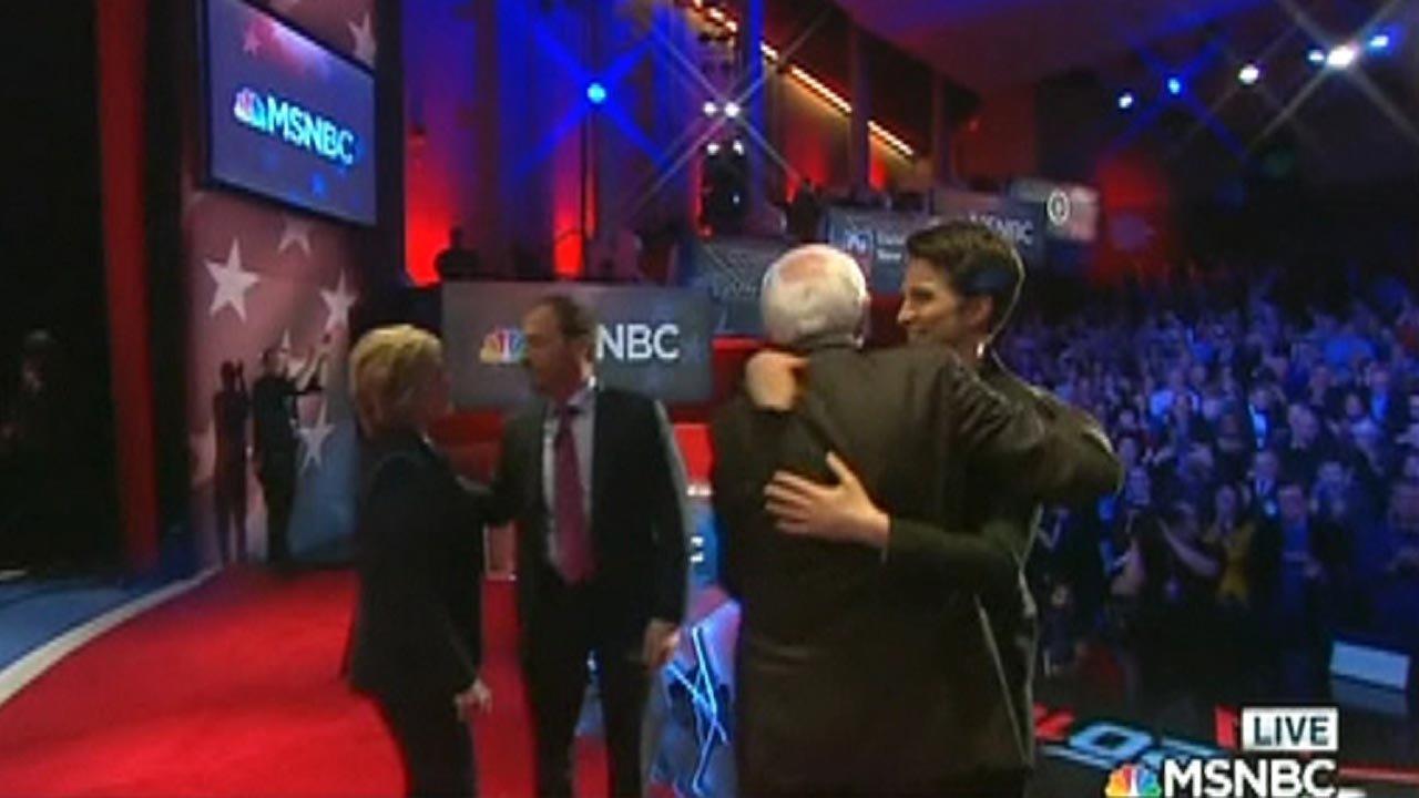 MSNBC debate moderator under fire for hugging candidates