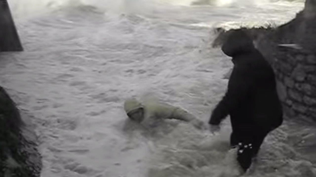 Wicked wave nearly sweeps elderly couple out to sea