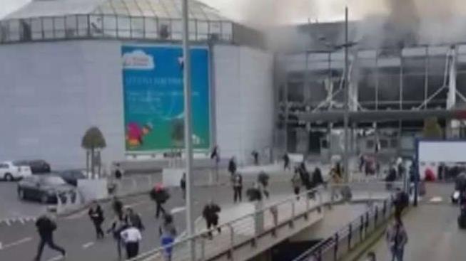 Massive manhunt under way after explosions rock Brussels