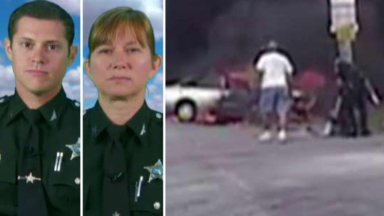Officers who pulled woman from burning car speak out