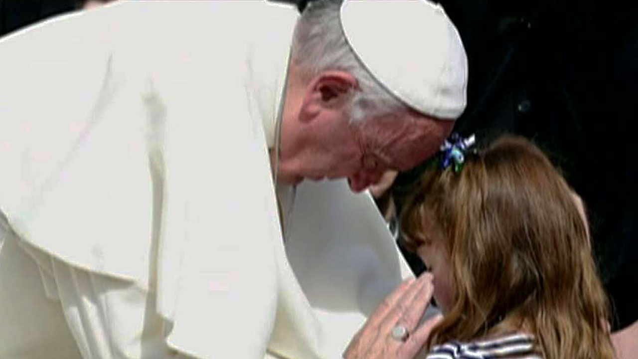 Pope Francis blesses little girl who's losing her sight