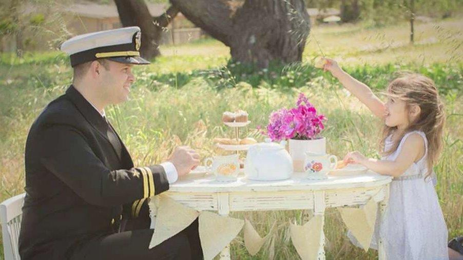 Military parents sit down for tea with their daughters
