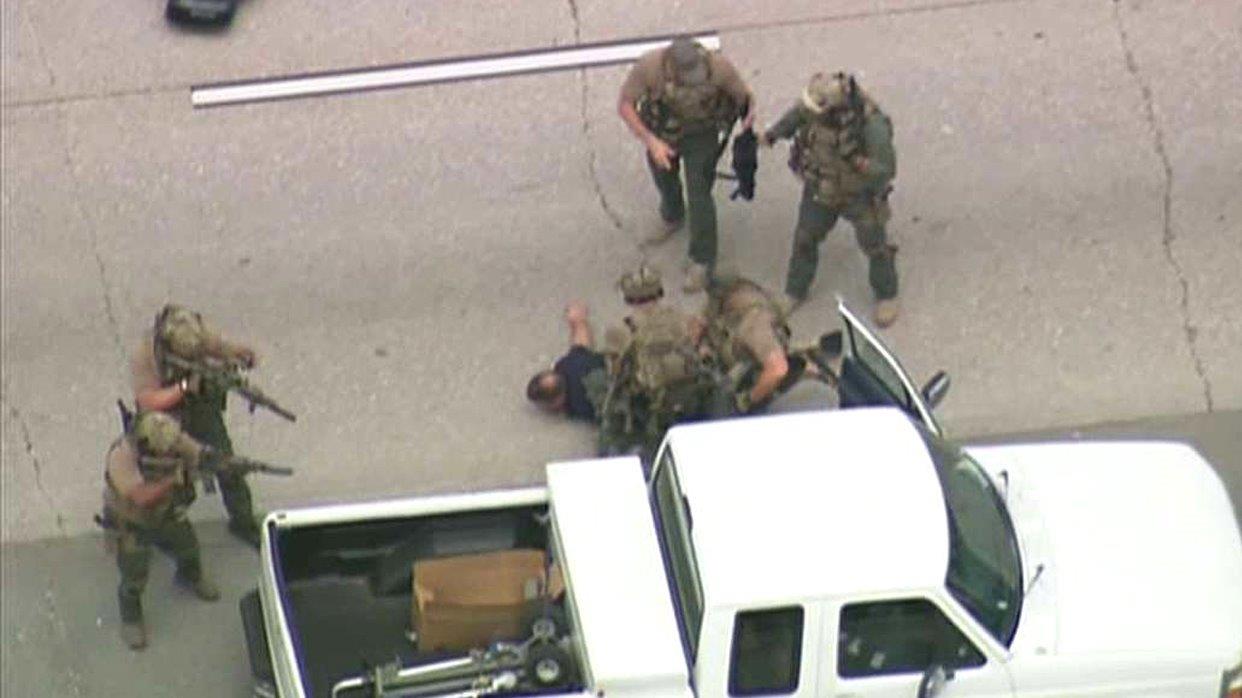 Police swarm suspect to end armed standoff