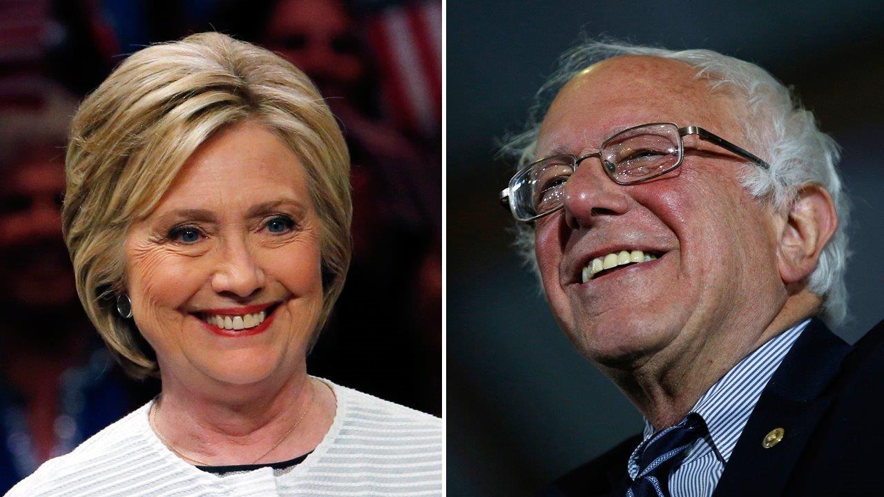 Hillary makes history as Bernie vows to continue to fight