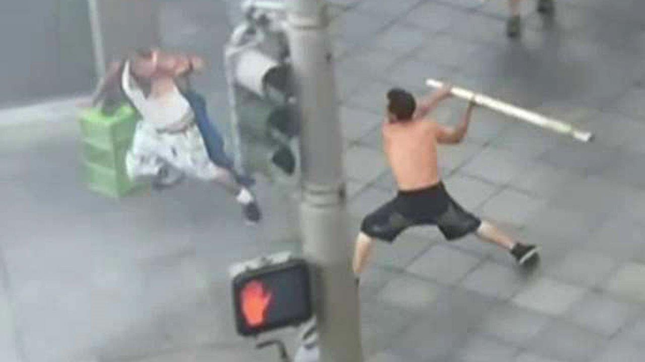Shirtless man attacks bystanders with pole