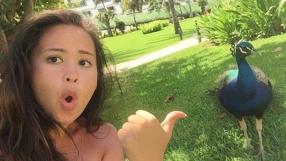 Angry peacock lunges at girl taking selfie 