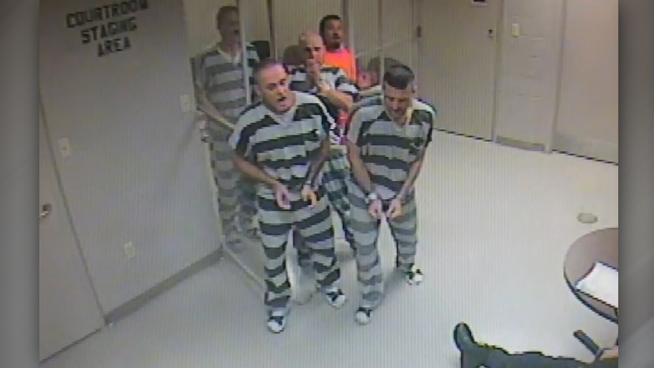 Inmates break free from holding cell to help officer