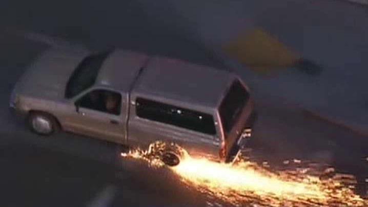 Sparks fly as police chase stolen SUV through Los Angeles