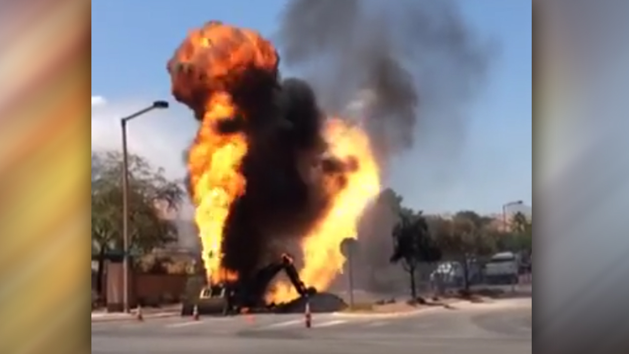 Natural gas fire roasts backhoe, shoots flames into sky