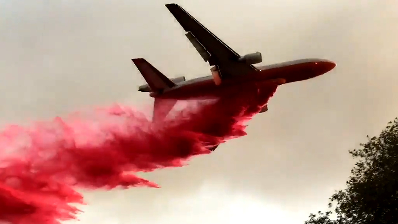 Look out below! Tanker swoops low to fight wildfire