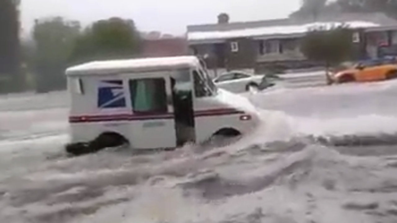 US Postal truck slammed by raging floodwaters