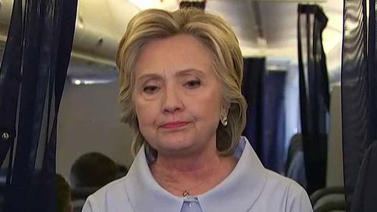 Clinton takes questions from media aboard campaign plane 