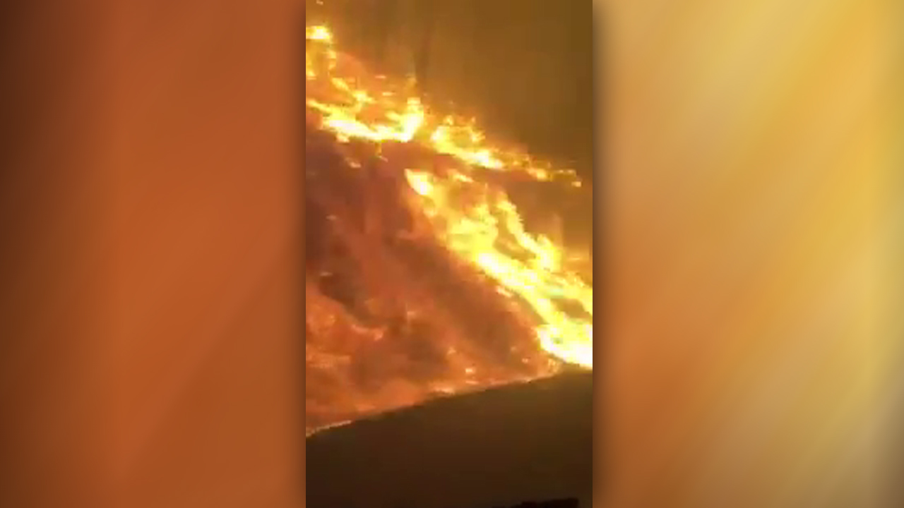Firefighter films dramatic drive through raging blaze