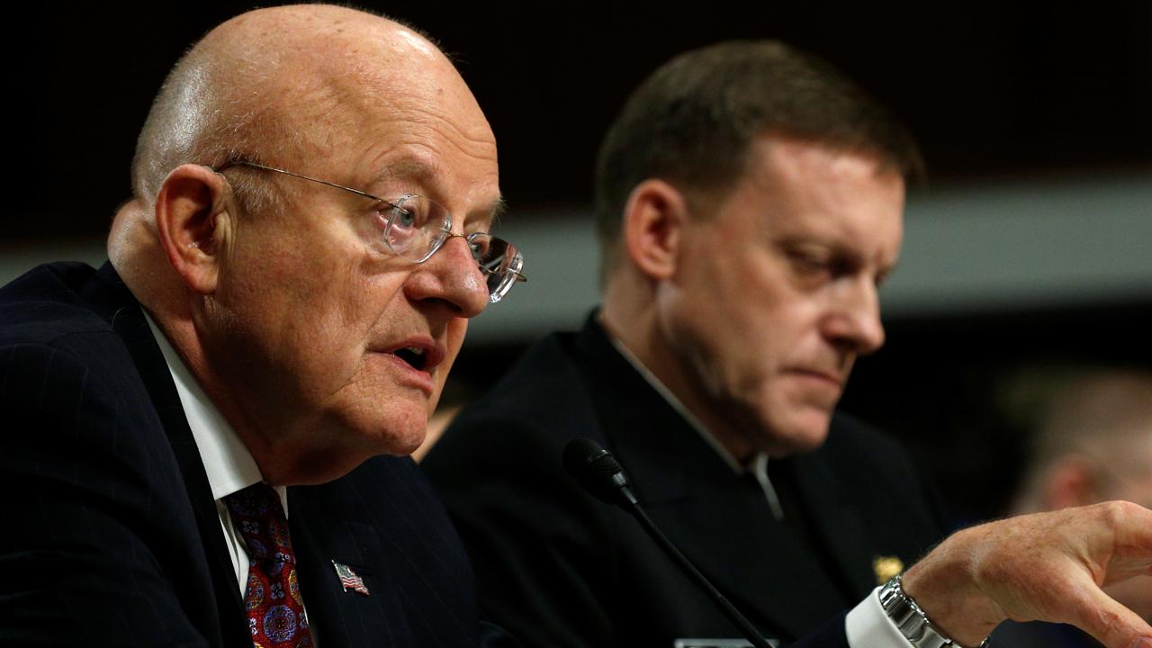 Intelligence officials reject Trump's view on hacking