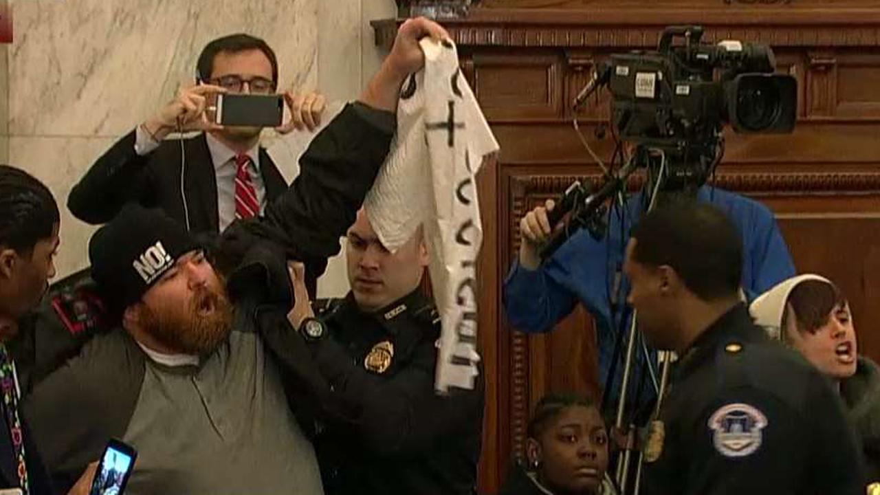 Protesters interrupt Sessions' response to Gitmo question