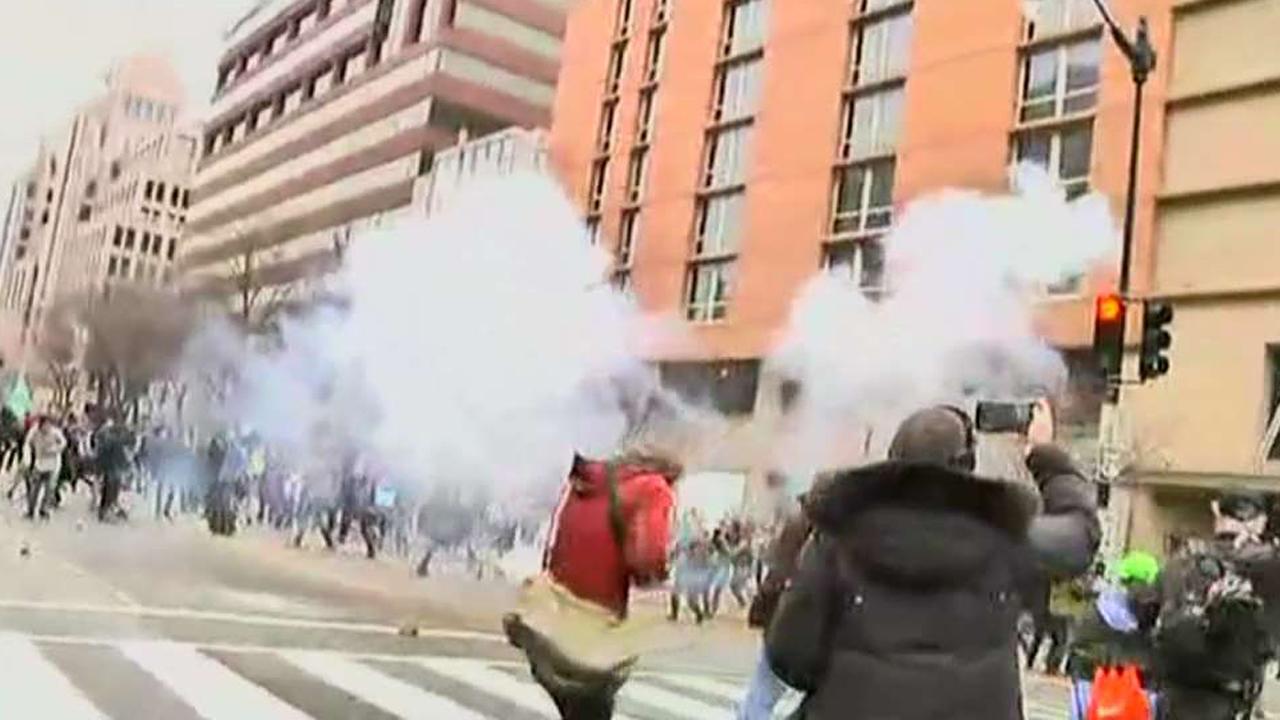 Police clashing with protesters after the inauguration