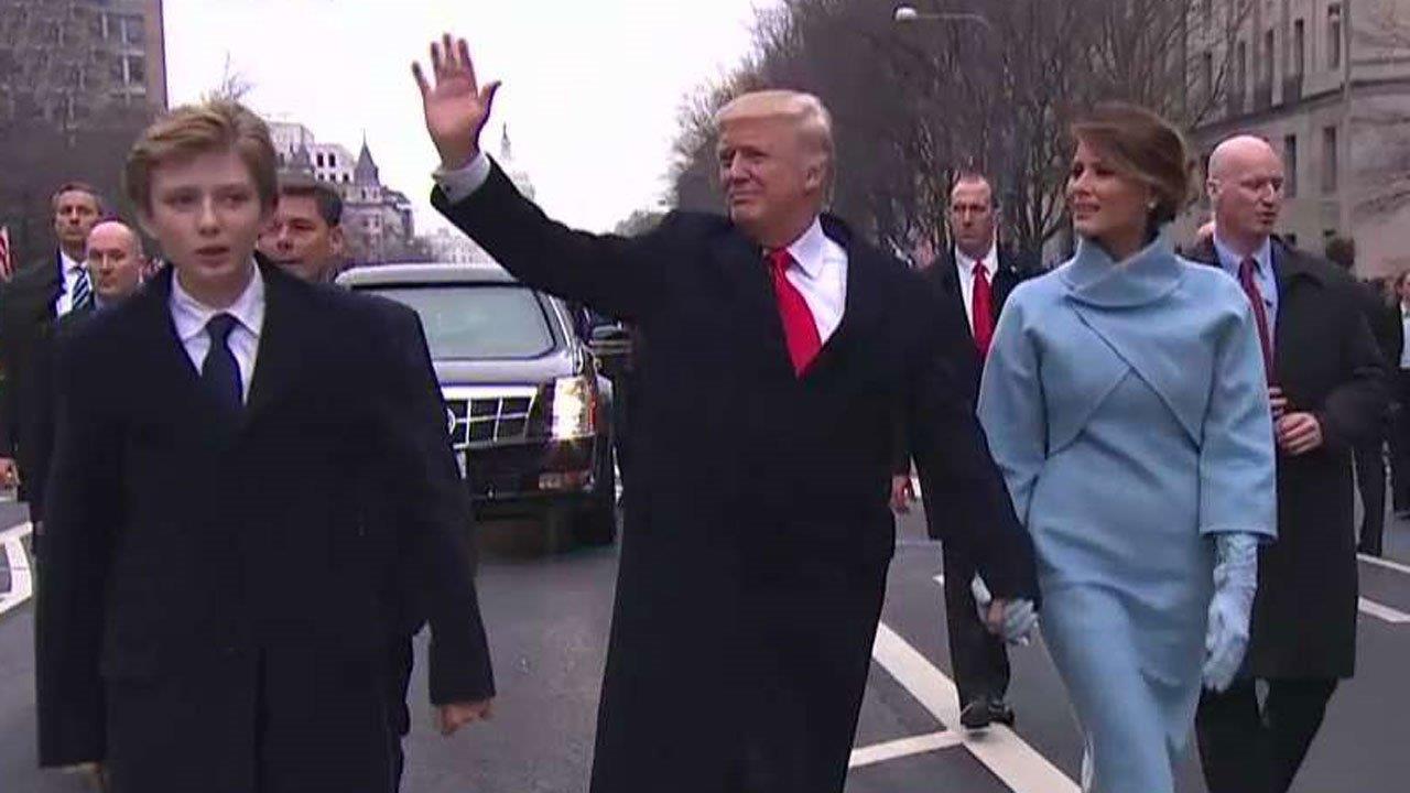 President Donald Trump greets supporters along parade route