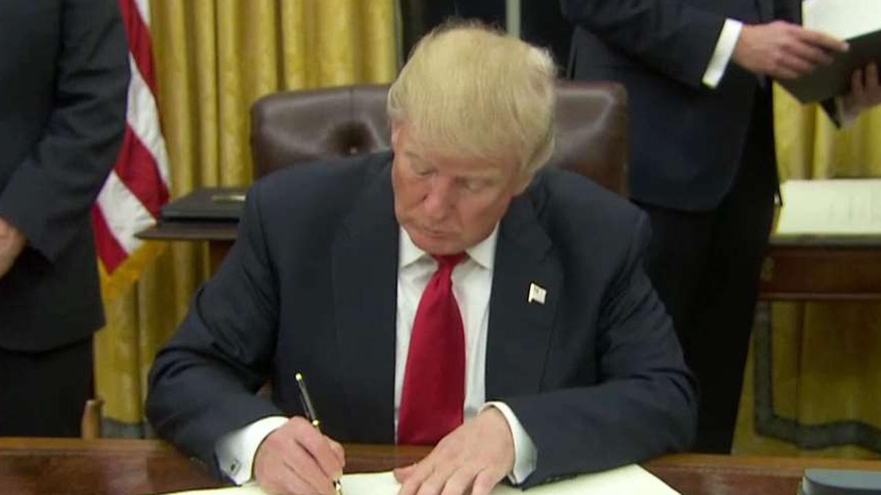 President Trump begins signing executive orders 