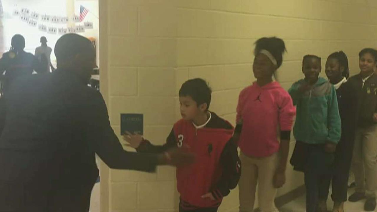 Teacher fires up students with personalized handshakes
