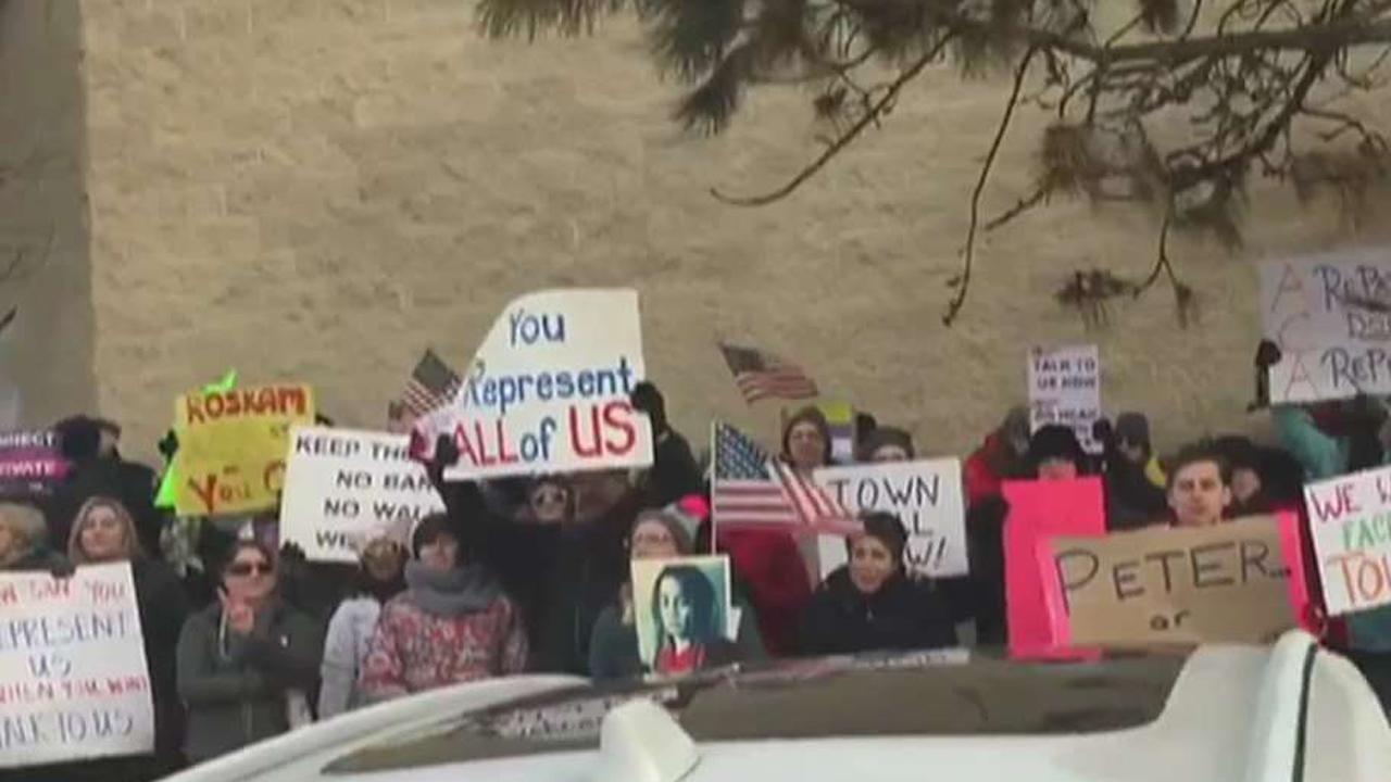 Lawmakers face rowdy town hall crowds