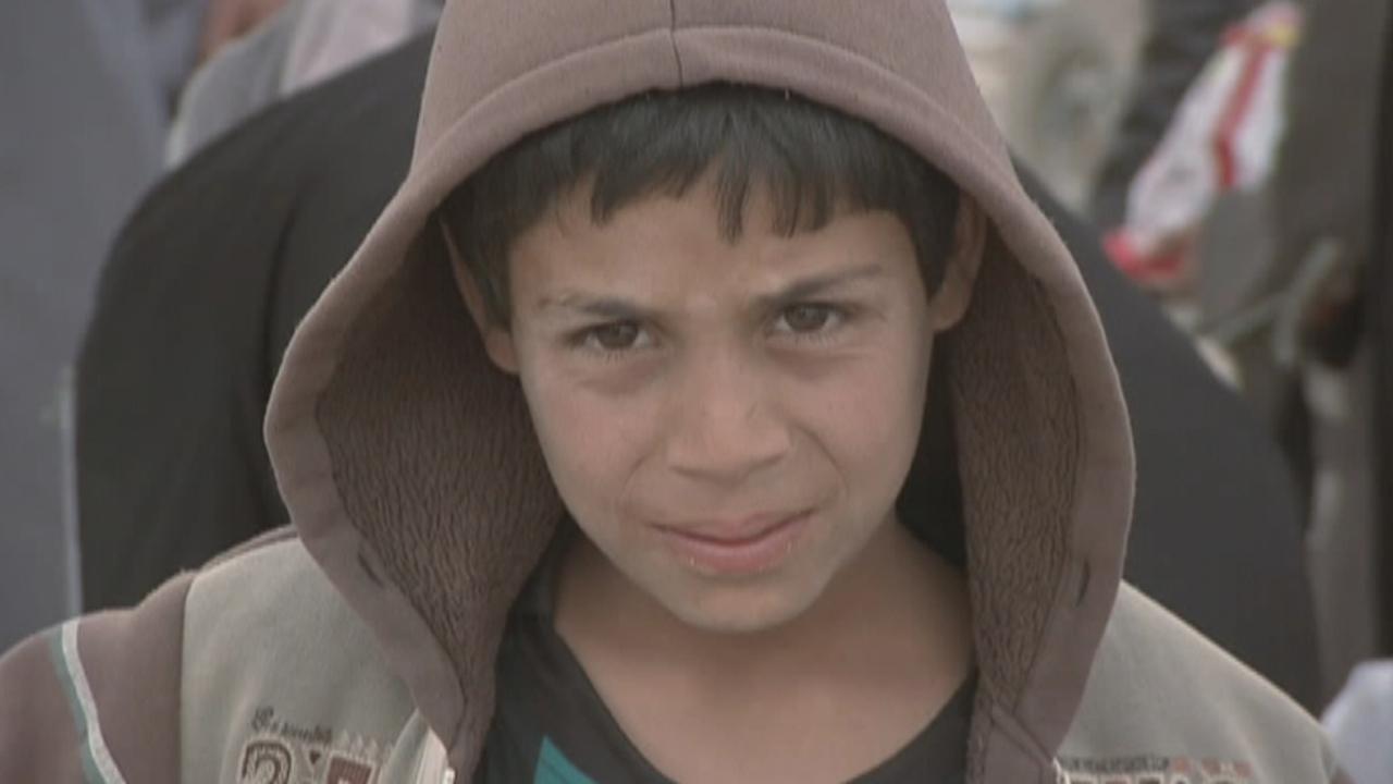 Families fleeing Mosul reach relative safety of refugee camp