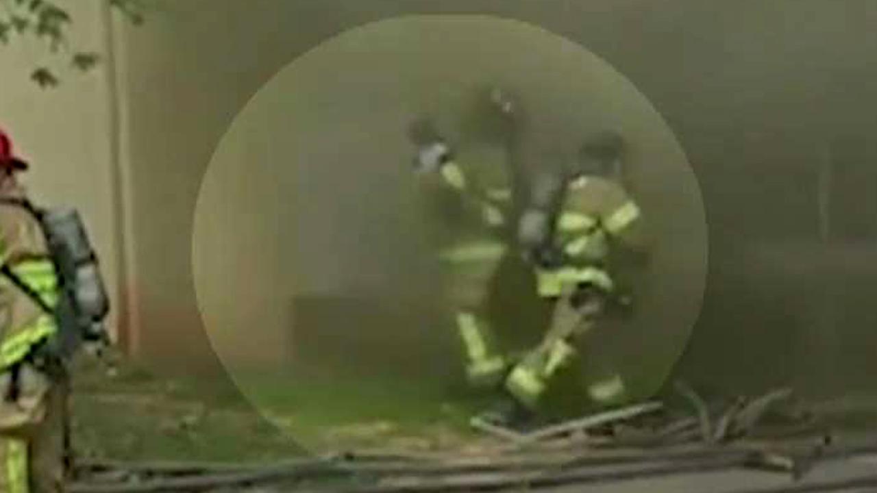 Hero firefighter catches baby dropped from burning building
