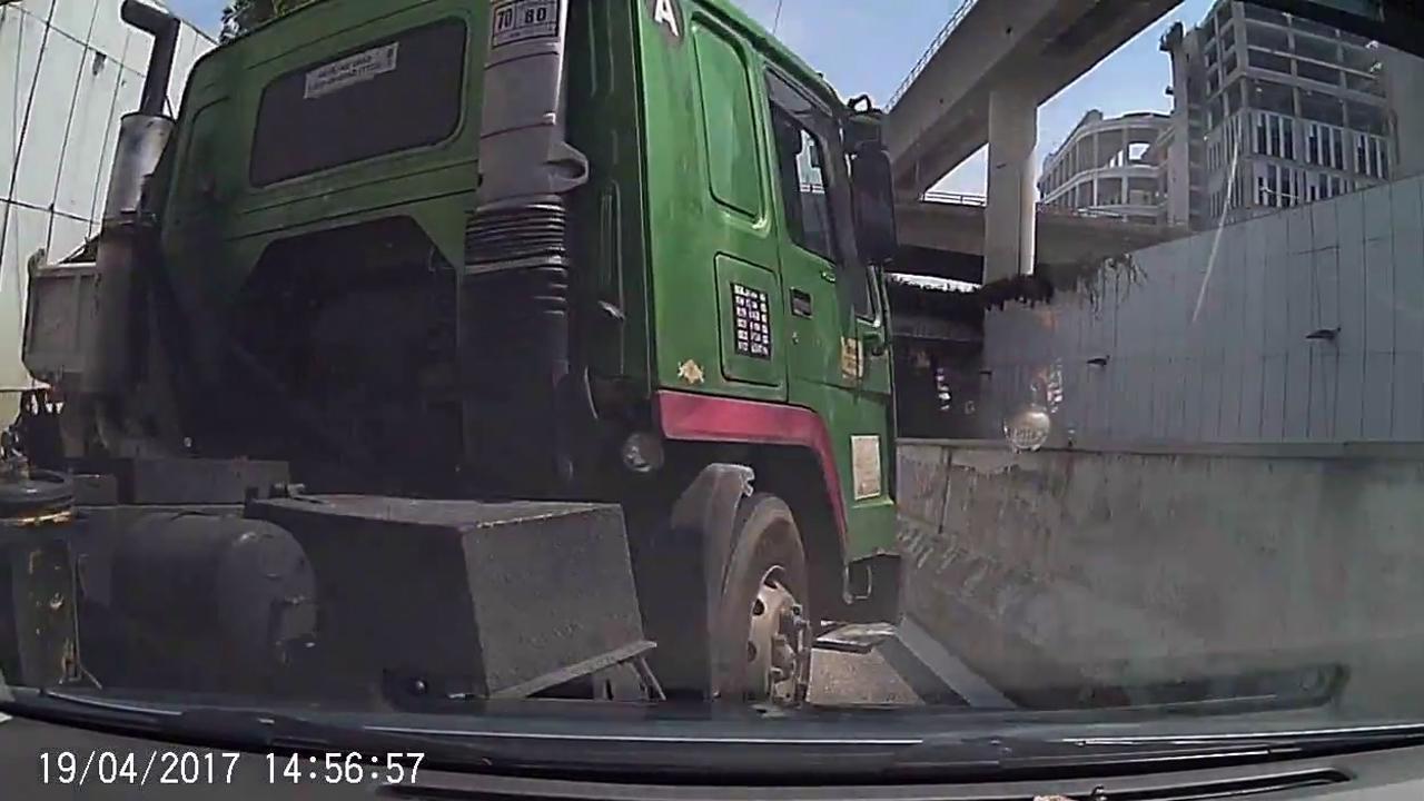 Swerving truck crushes car into guard rail