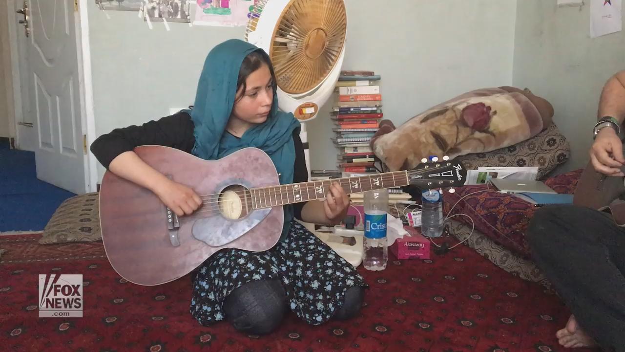 Afghan suicide bomb survivor heals through playing guitar