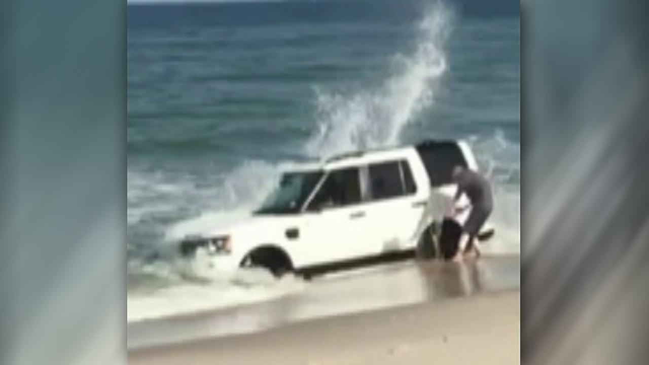 SUV sinks into beach in photoshoot gone wrong