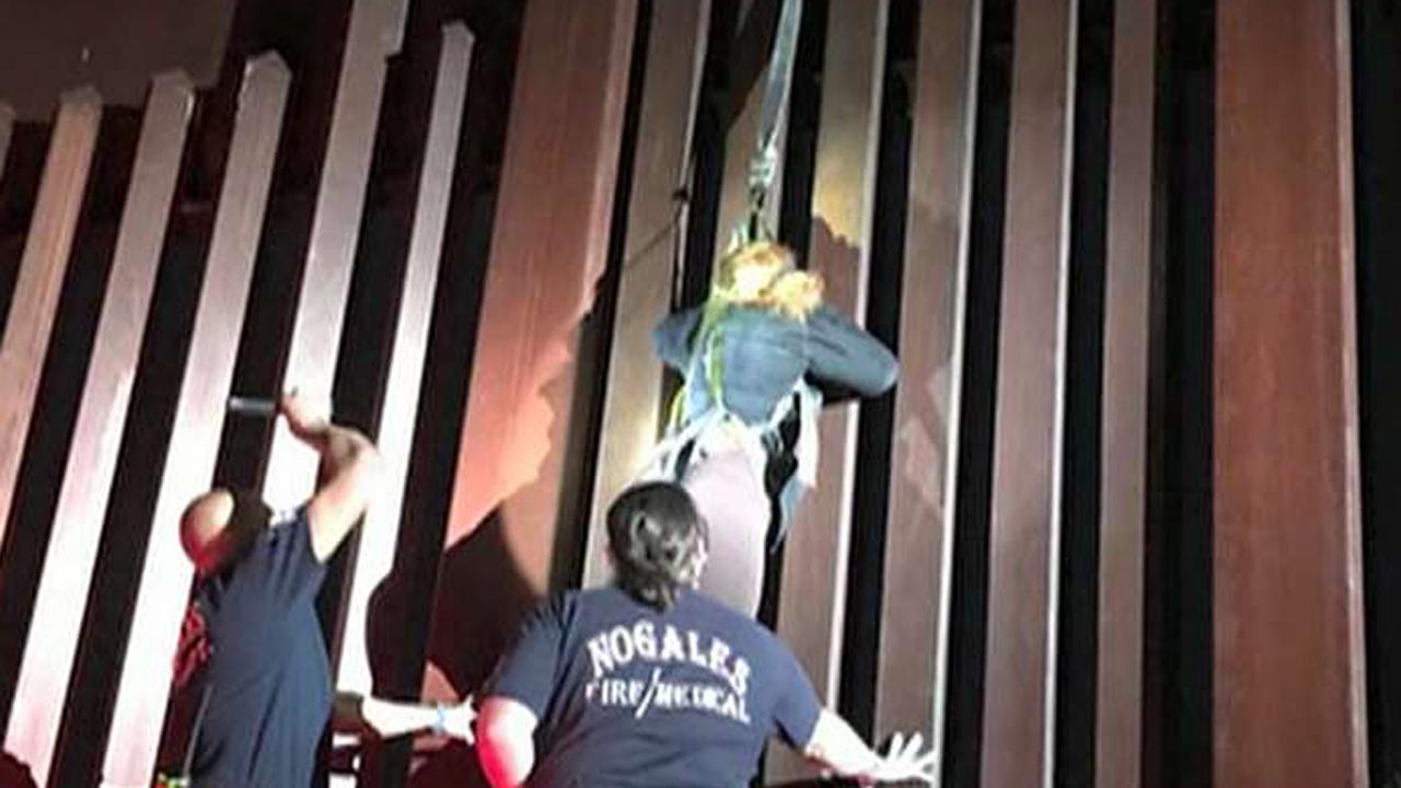 Border patrol agents rescue woman dangling from border wall