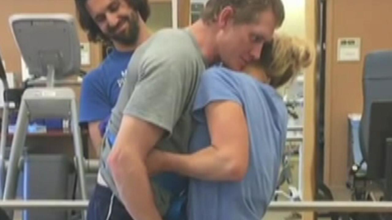 Watch recovering Navy SEAL stand, embrace wife