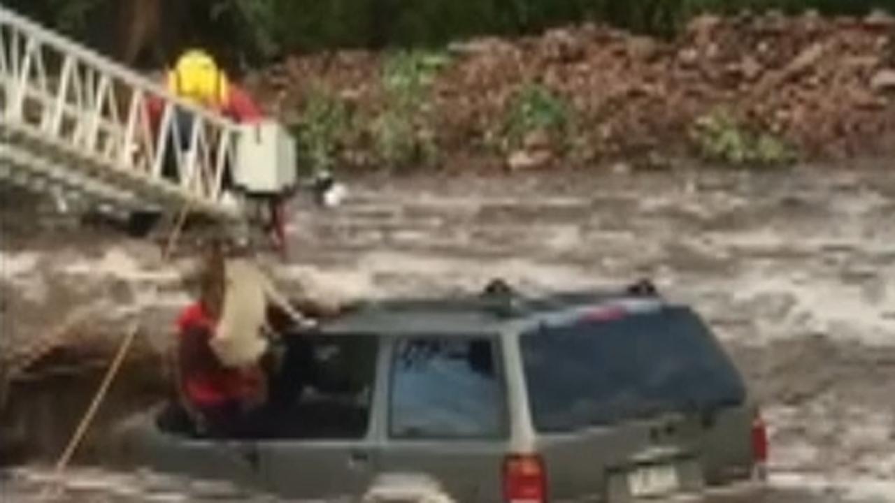 Dramatic swift water rescue of driver and his dog