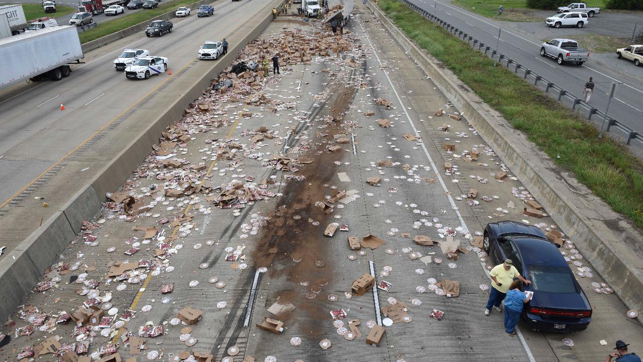 Pizza truck spills hundreds of frozen pizzas across highway
