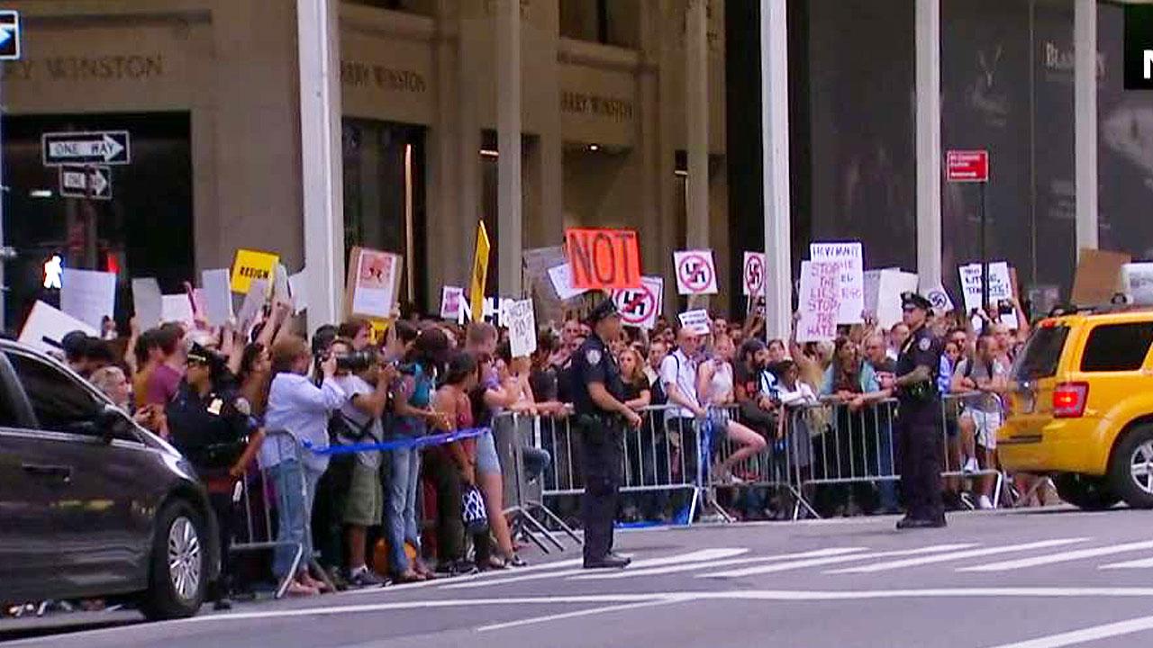 Protesters await the president's arrival at Trump Tower