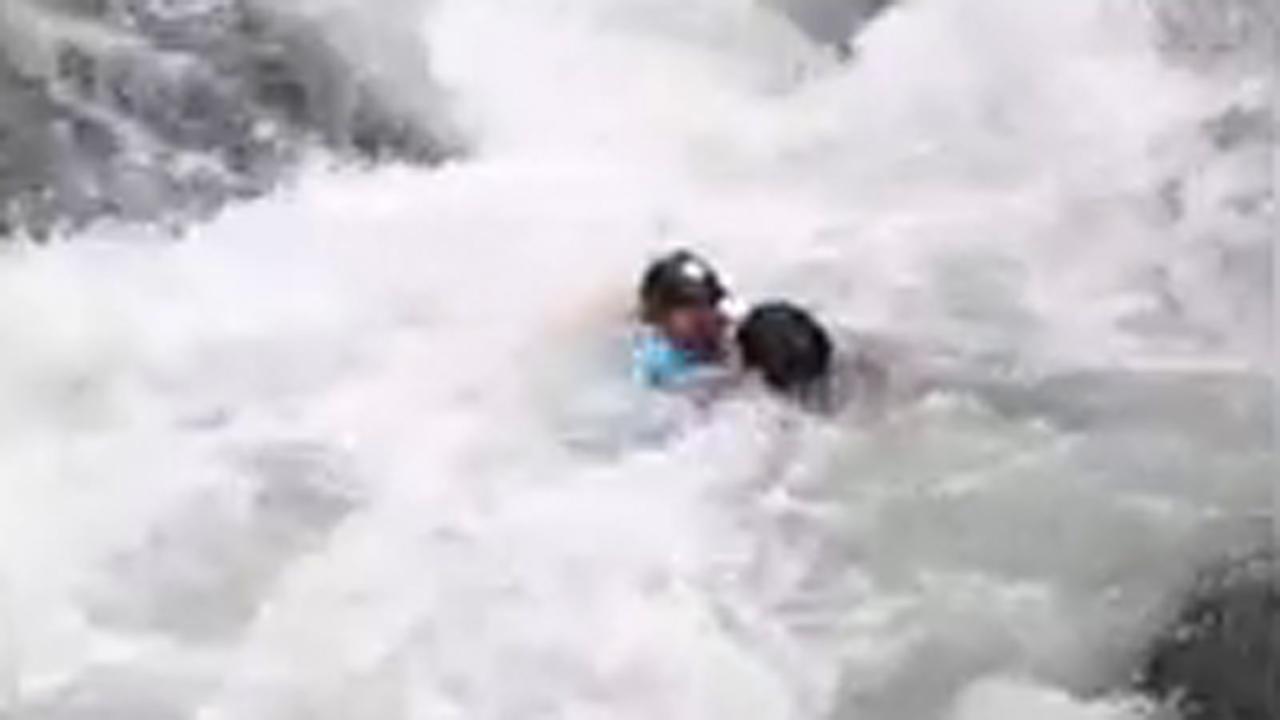 Bystander leaps into rapids to save kayaker in daring rescue
