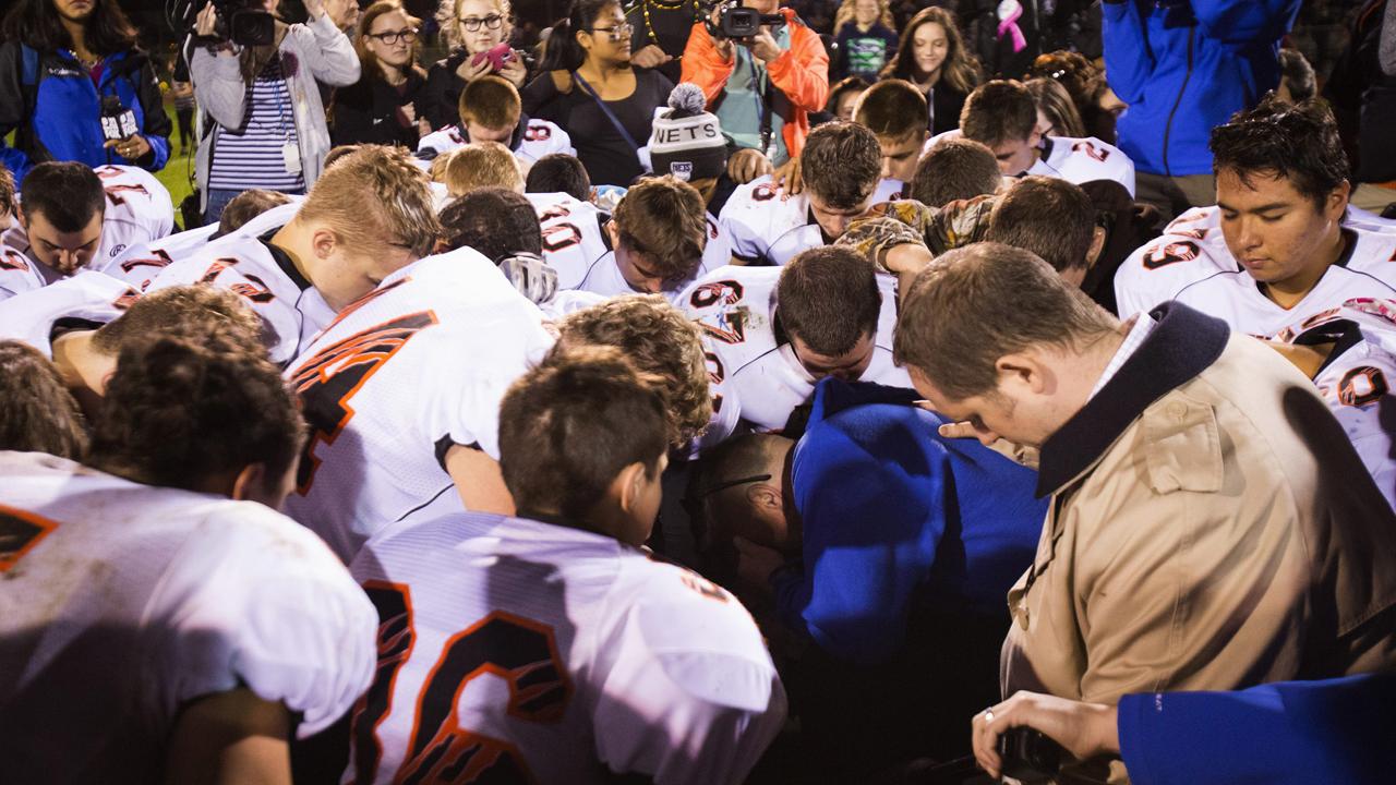 Court rules high school football coach cannot pray on field