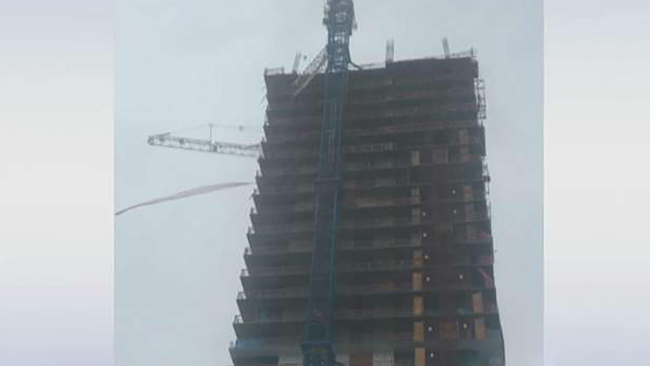 Construction crane collapses onto building in Miami 