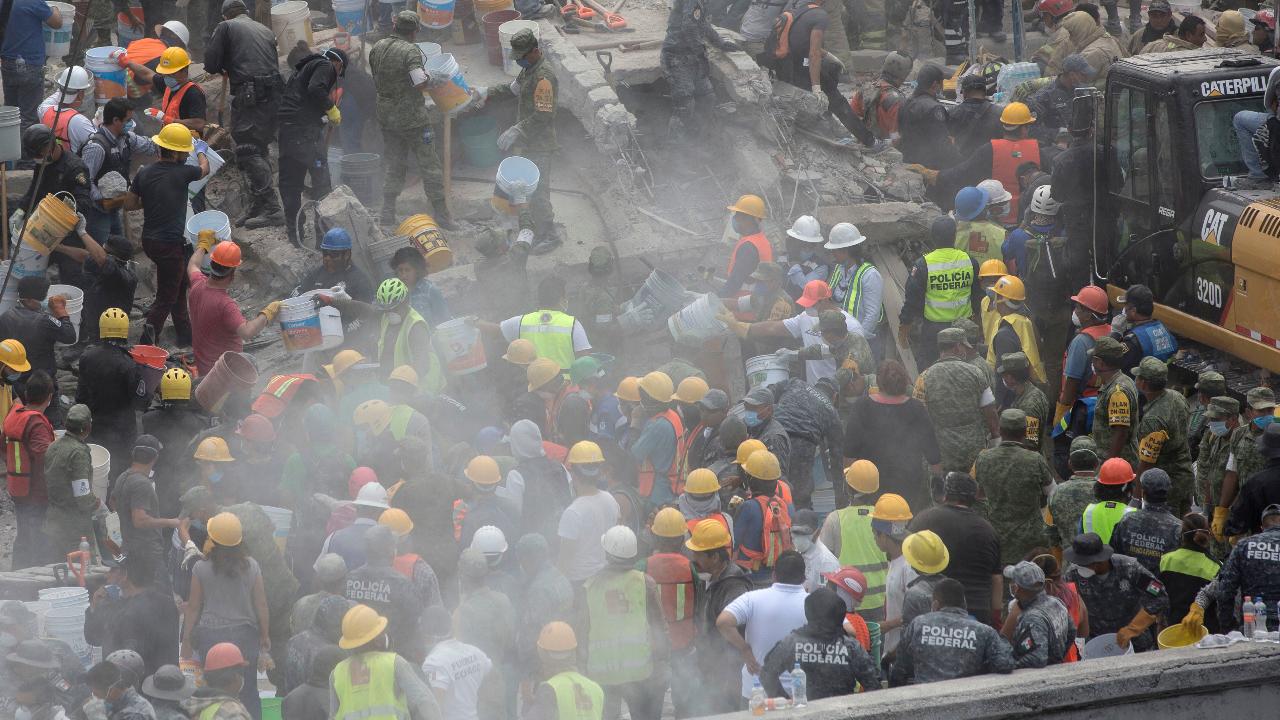 Crews race to save trapped schoolgirl from earthquake rubble