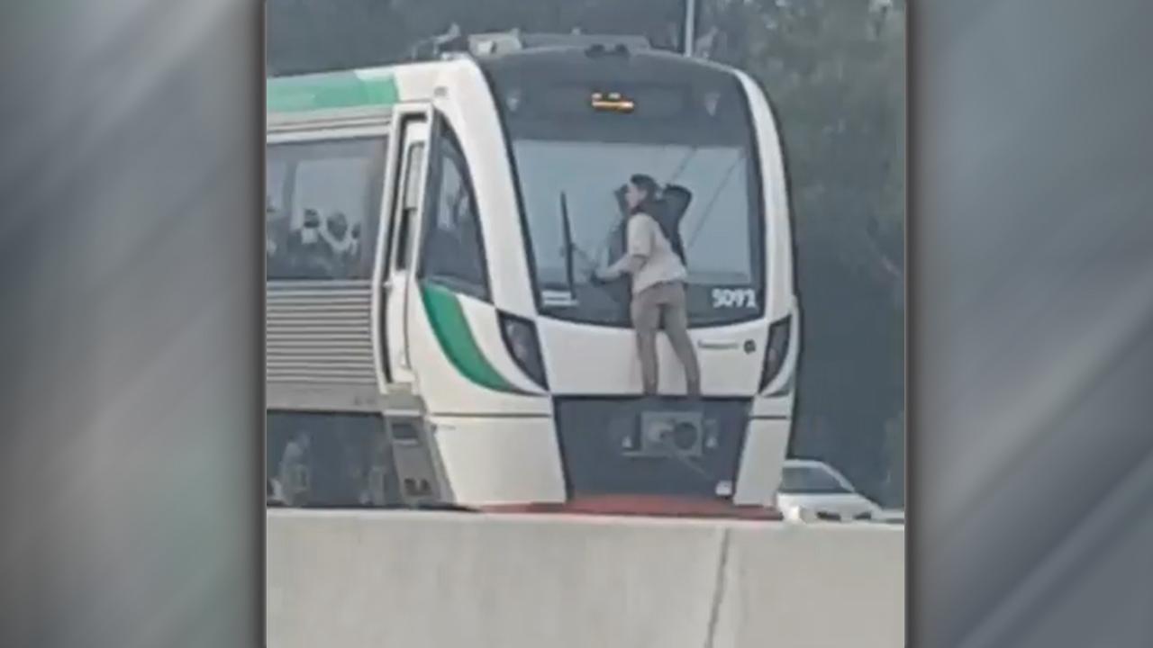 Man clinging to back of speeding train shocks motorists
