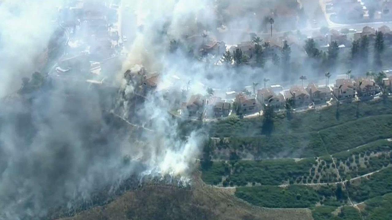 Wind-driven wildfire threatens homes in Anaheim, California