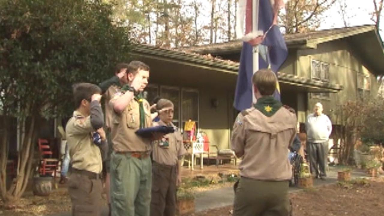 Boy scouts help veteran retire his flags