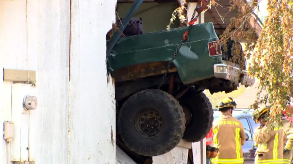 Truck crashes into home, killing one boy, injuring another