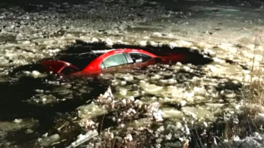 Man rescued after car plunges into frozen pond