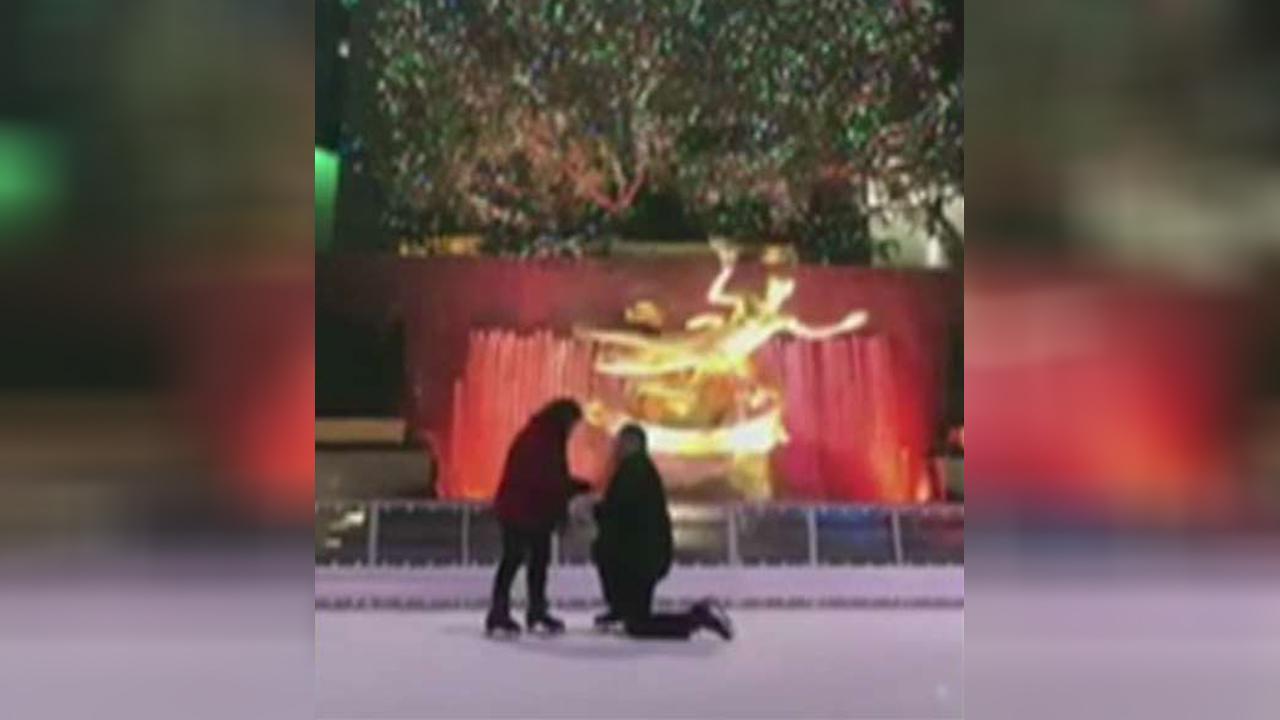 Woman wipes out on ice rink as boyfriend proposes