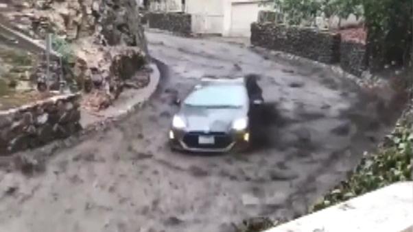 Couple evacuating in car swept away by fast-moving mudslide